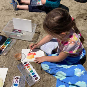 children paint at beach