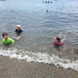 children play at waters edge
