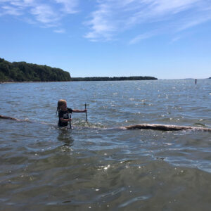 child floats on log in water