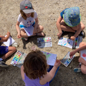 children paint on beach
