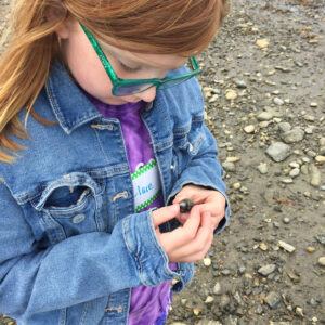 girl holds snail shell
