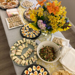 spread of food options and flowers on folding table