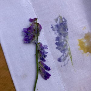 purple flowers pressed onto white fabric