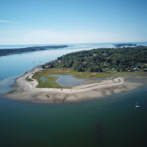 aerial view of curved beach peninsula