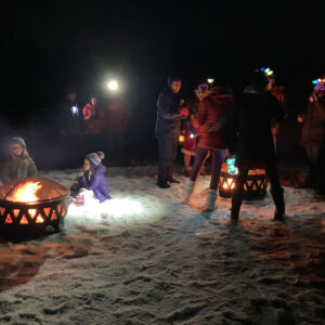 people gather at fire pits