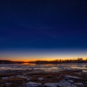 view over icy water at sunset