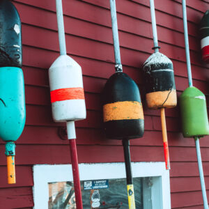buoys lined up on wall of building