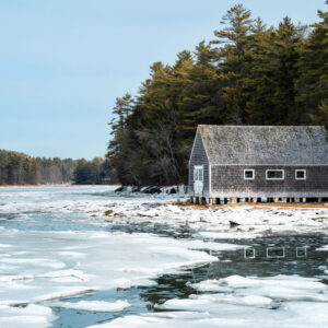 ice around shack at edge of water