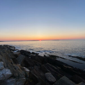 Sunrise over rocky shore and open ocean