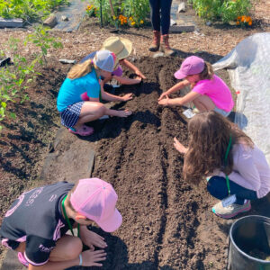 children planting at community garden