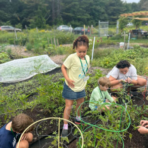 children help at community garden