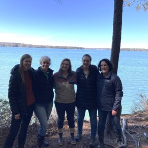 five women smile at camera