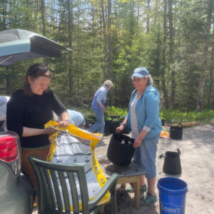 woman opens bag of potting soil
