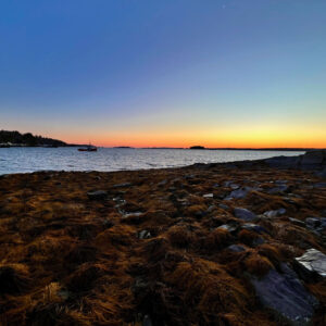 hint of orange at end of sunset over a cove