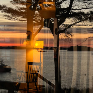 reflection of sunset overlaid with inside of house
