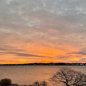 pink sunset over the ocean with land in the distance