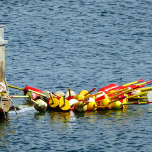 red and yellow buoys float in calm water