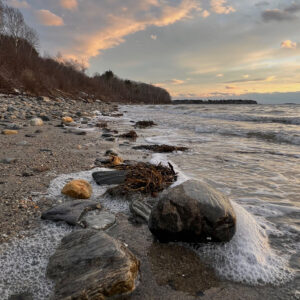Sunset over rocks on beach