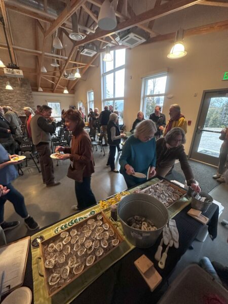 people talking and eating oysters