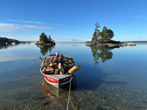 boat full of boards in clear calm water