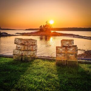 Lobster traps in front of the water at sunset
